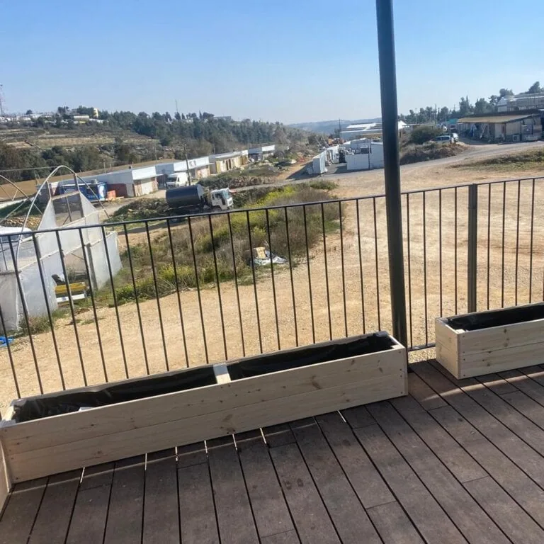 אדניות עץ נמוכות דגם נתנאל על דק מרפסת מול נוף פתוח